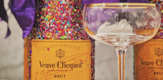 Glitter Veuve Clicquot Bottles from Turning Tables next to a gold rimmed coupe glass