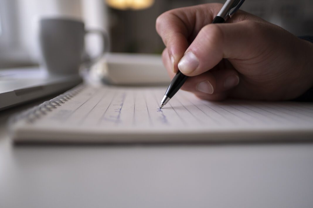 Taking notes on a ring binded notepad INF